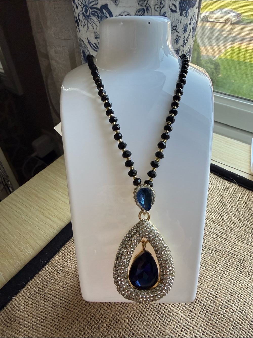 Elegant Black Bead Necklace with Deep Blue Teardrop Pendant